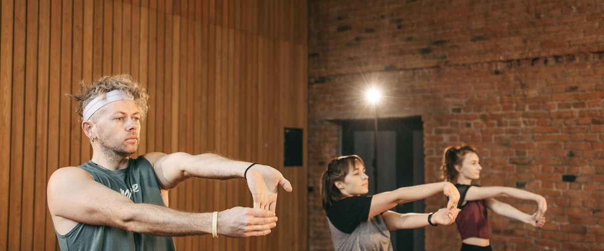 Group of diverse people doing gentle stretches outdoors